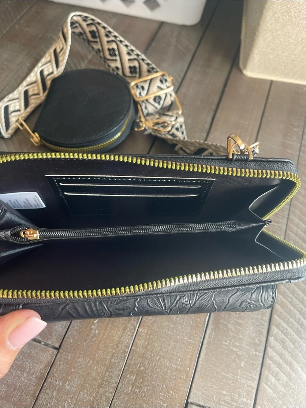 Black Embossed Crossbody Wallet with Patterned Strap and Coin Pouch